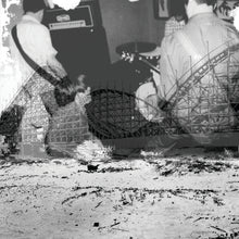 Load image into Gallery viewer, Black and white image of a person playing guitar with a roller coaster in the background